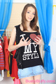 Cupping breasts in black top in denim skirt