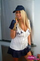 Wearing baseball uniform holding bat