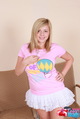 Hand on hip wearing tshirt in white skirt