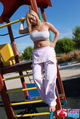 Standing barefoot on playground equipment hand on hip big tits in boob tube