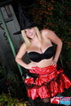Standing with hands on hips wearing bra