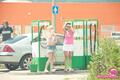 Two girls working at car wash wearing short skirts